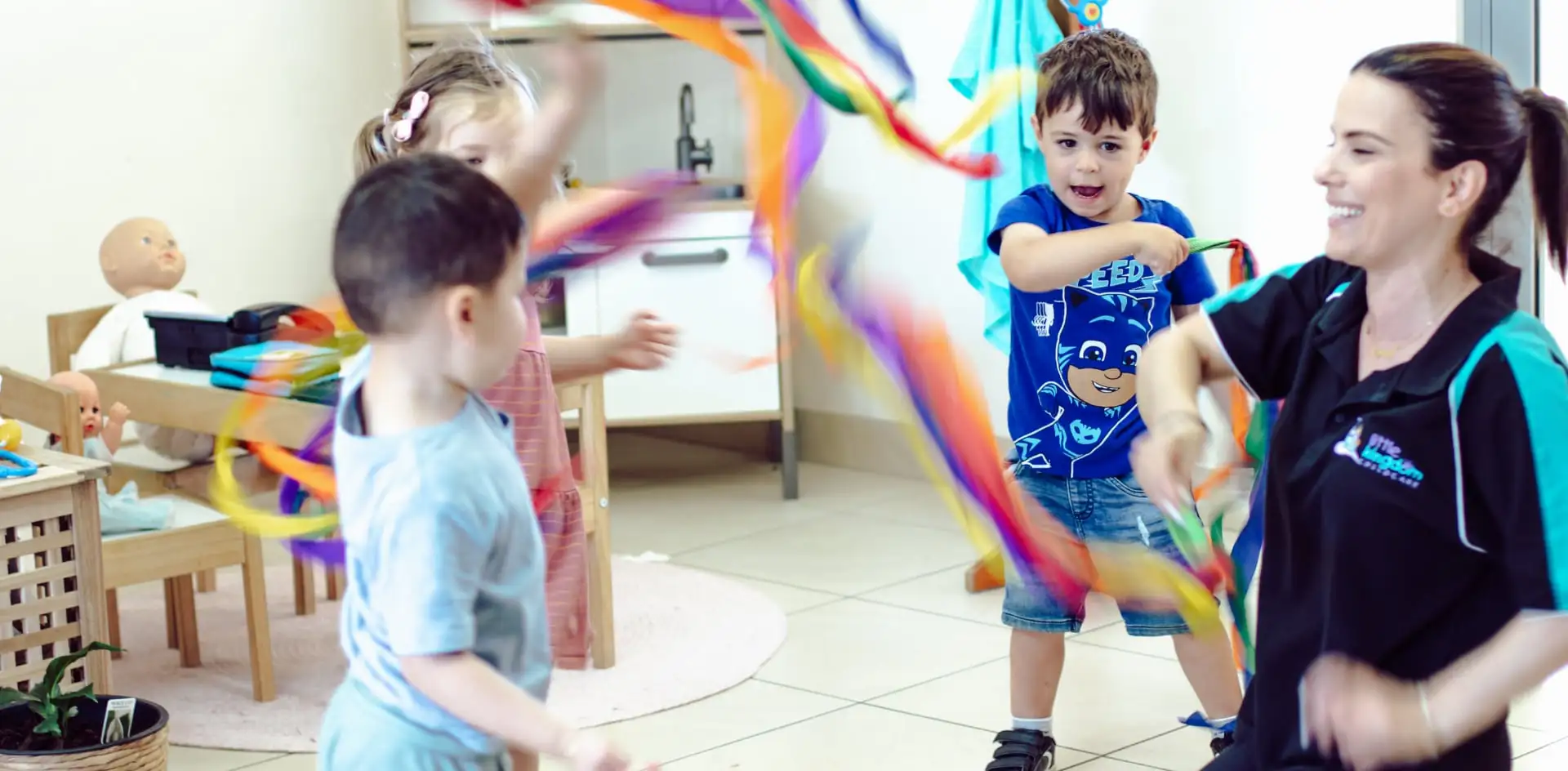 Children and teacher playing with ribbons - Little Kingdom Childcare, Mt Tarcoola, Geraldton